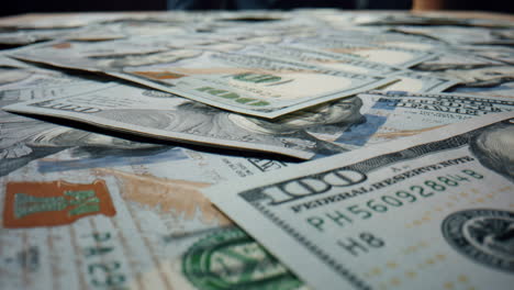 Hundred-dollars-falling-table-close-up.-Bills-american-currency-scattering.