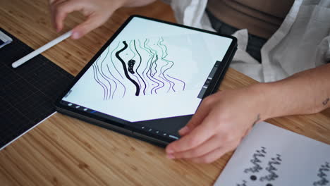 Woman-hand-drawing-tablet-home-office-closeup.-Lady-fingers-zooming-tab-screen