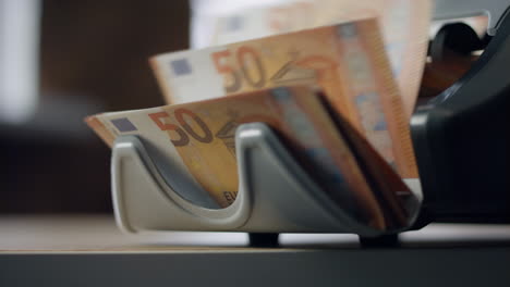 Closeup-counter-calculating-euro-bills.-Machine-counting-european-currency.