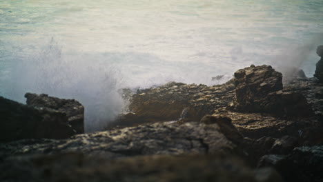 Sea-waves-hitting-rocks-making-explosion-closeup.-Storm-water-foaming-breaking