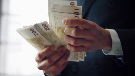 Male-hands-holding-money-cash-of-european-currency-close-up.-Man-counting-bills.