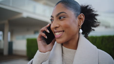 Cheerful-woman-talking-cell-sharing-good-news-closeup.-Happy-african-american