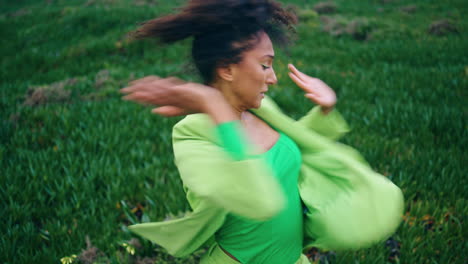 Energetic-woman-performer-dancing-on-green-grass.-Girl-practicing-contemporary.