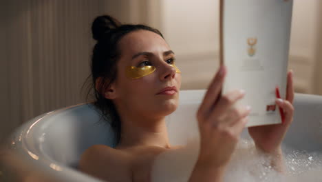 Chilling-lady-read-novel-enjoying-spa-procedures-at-bath.-Woman-laying-bathroom