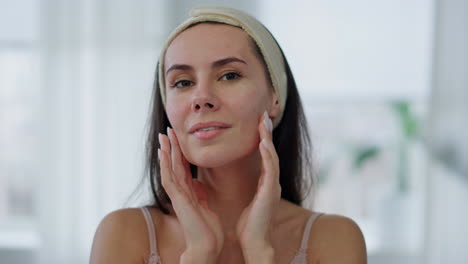 Positive-model-facial-treatment-at-home-mirror-pov-portrait.-Woman-face-massage