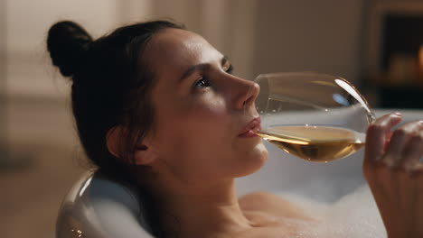 Sexy-woman-sipping-champagne-at-luxury-bathroom-closeup.-Girl-chilling-bathtub