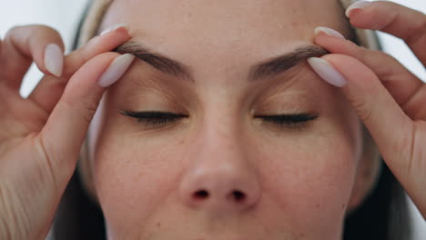 Woman-hands-massaging-face-indoor-extreme-closeup.-Lady-enjoying-daily-treatment