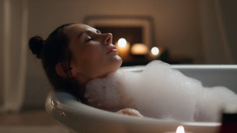 Groomed-girl-laying-foam-bathroom-closeup.-Carefree-woman-washing-skin-relax