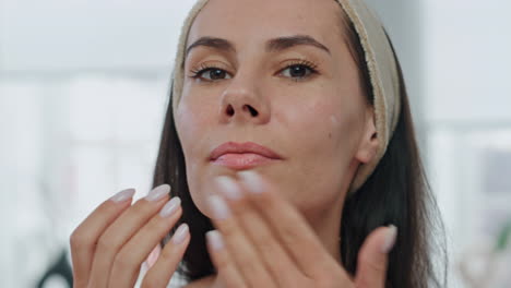 Portrait-woman-moisturize-face-cream-indoors.-Pov-view-lady-moisturizing-skin