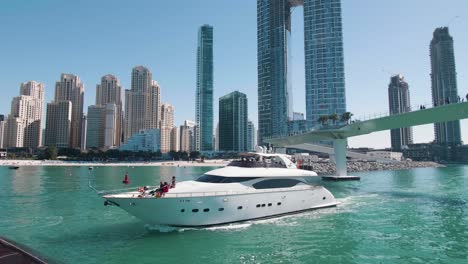 Luxury-Yacht-Passing-Sunshine,-Dubai-Marine