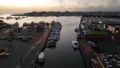Rising-aerial-reveal-of-American-harbor-and-boat-dock-at-sunrise