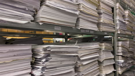 in-a-file-archive-there-are-shelves-filled-with-stacks-of-paper