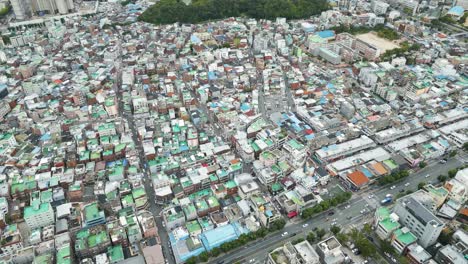 Looking-down-at-the-busy-city-with-buildings-complex-and-city-park-on-the-day,-in-Daegu-city,-Korea