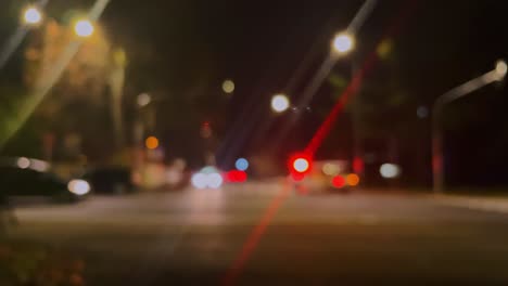 Police-or-ambulance-car-flashing-lights,-traffic-accident,-city-street-in-soft-focus