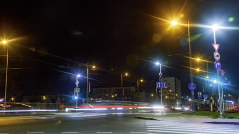 Timelapse-of-city-rush-hour-traffic-over-the-Liepaja-tram-bridge,-city-landscape,-traffic-light-streaks,-fast-moving-trams-and-pedestrians,-wide-shot