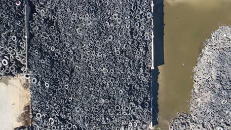 Aerial-top-down-view-over-waste-rubber-tires-at-recycling-factory