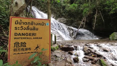 Warning-sign-at-Waterfall-in-lush-jungle