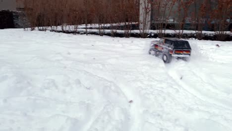 A-remote-control-car-drives-fast-in-deep-snow-in-winter