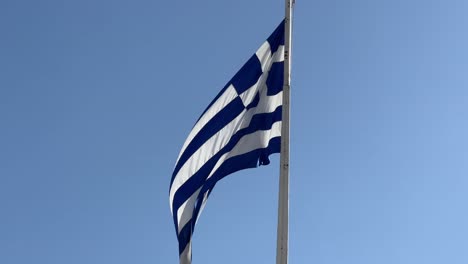 Greece-national-flag-waving-in-the-Acropolis-of-Athens