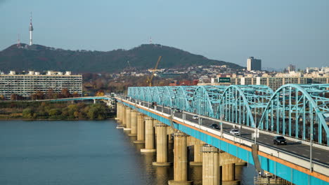 Commuter-traffic-drives-across-Dongjak-Bridge-over-Han-River,-Seoul-South-Korea