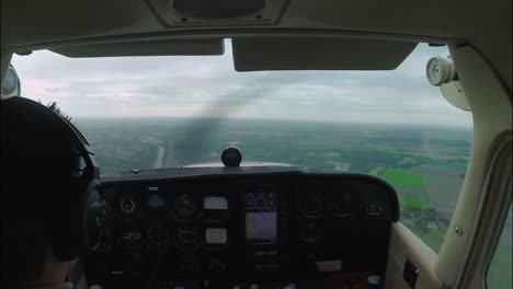 Young-Male-Pilot-Flying-Small-Airplane-Along-Highway-And-River,-Hobby,-Free-Time,-Cessna-172,-Windy-Conditions