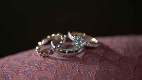 Close-up-of-three-wedding-rings-with-precious-gems