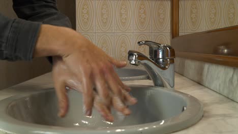 Anonymous-person-washing-hands-closeup-with-foam-soap-hygiene-cleansing