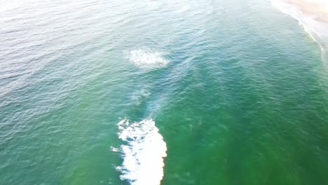 Bright-Blue-Ocean-Rippling-On-A-Sunny-Day---Touristic-Beach-In-Gold-Coast,-QLD,-Australia---aerial-drone,-slow-motion