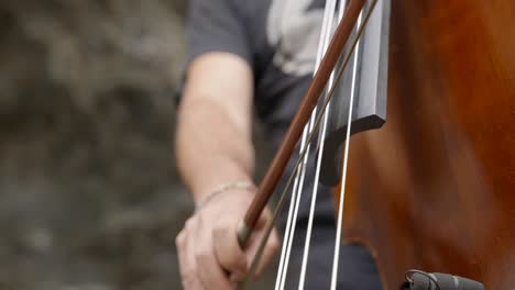 Beautiful-classic-wooden-cello-being-played,-close-up-on-strings-and-bow
