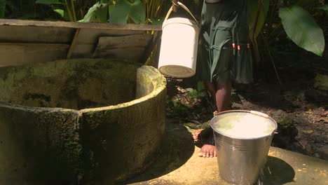 A-girl-using-a-bucket-to-refill-water-from-a-water-well