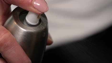 Female-Hand-Pushing-Nozzle-Of-Oil-Spray-Bottle