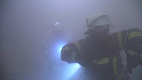 Two-firefighter-in-dark-smokey-room