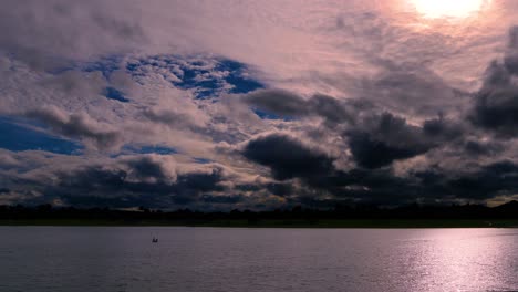 Time-Lapse-of-a-Dramatic-Sky-at-dusk,-with-normal-speed-for-the-lake