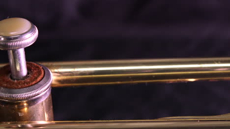 Panning-shot-of-the-mouthpiece-and-three-valves-of-a-brass-trumpet