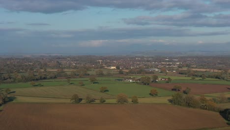 Telephoto-aerial-view-of-Moreton-In-Marsh,-autumnal-landscape-of-the-Cotswolds