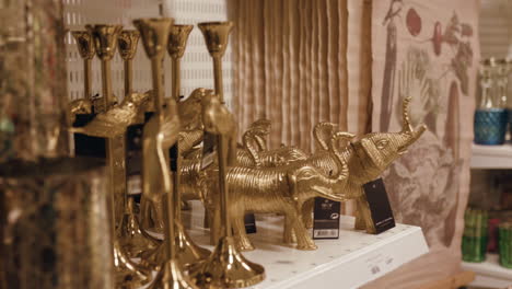 Close-up-shot-of-golden-items-for-sale-at-a-local-store-decor-interior-decorations-shop