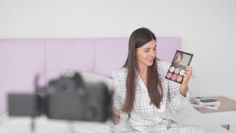 adorable-and-cheerful-girl-blogger-enthusiastically-talks-about-highlighter-on-camera