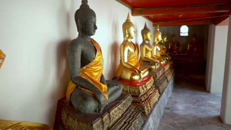 Row-of-beautiful-Buddha-Statues-at-Wat-Pho-in-Bangkok,-Thailand