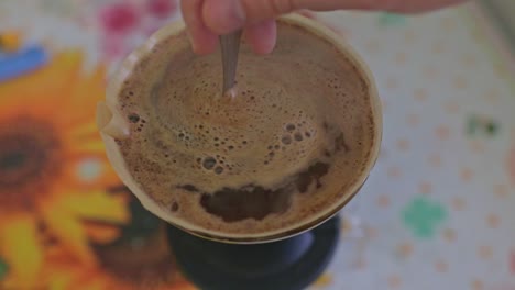 Rühren-Eines-Kaffeebetts-In-Einem-Tropfer-Voller-Heißem,-Dampfendem-Kaffee
