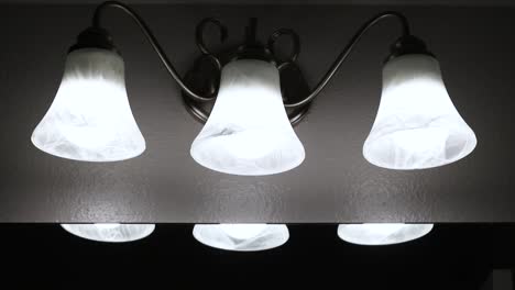 Bathroom-lights-turned-on.-Three-overhead-lighting-set