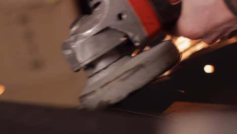 hand-using-grinder-on-metal