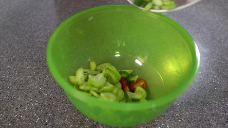 Making-vegan-salad-with-chopped-tomatoes-and-cucumbers