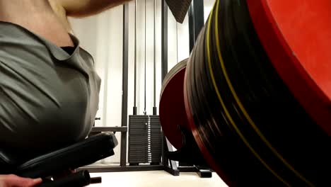 Man-lifting-heavy-weights-in-leg-press-machine