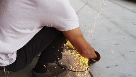 Piston-hand-grinding-at-a-garage-with-sparks-flying