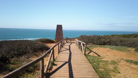 POV-Walking-on-Wooden-Beach-Path-Toward-Ocean-past-Grassland