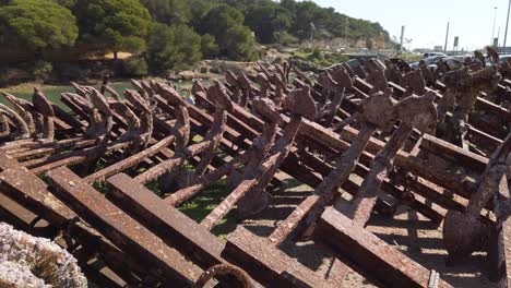 Tilt-Up,-Graveyard-of-Rusty-Anchors-used-for-Tuna-Fishing-in-Barbate,-Spain
