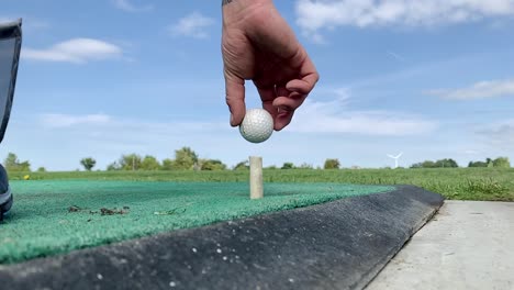 Slow-Motion-golfer-placing-the-ball-on-a-tee-before-hitting-initial-shot