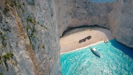Aerial-Footage-Of-Tourists-Visiting-Shipwreck-Bay,-Navagio-Beach,-Zakynthos,-Greece