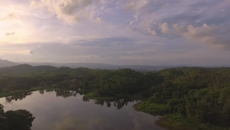 Drone-view-of-a-lake-during-a-sunset-in-Venezuela-with-dramatic-orange-sky