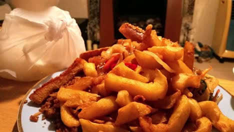 Chinese-takeaway-order,-fattening,-greasy-unhealthy-chips-dolly-left-across-table-closeup-in-home-living-room